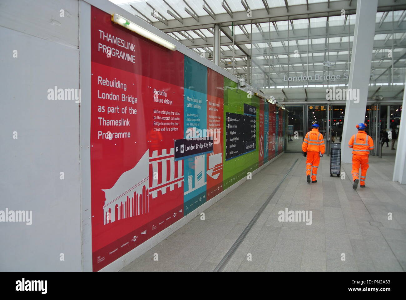 Link To The Past Stock !   Photos Link To The Past Stock Images Alamy - two unidentifiable network rail workmen walking past a poster board advertising thameslink programme london